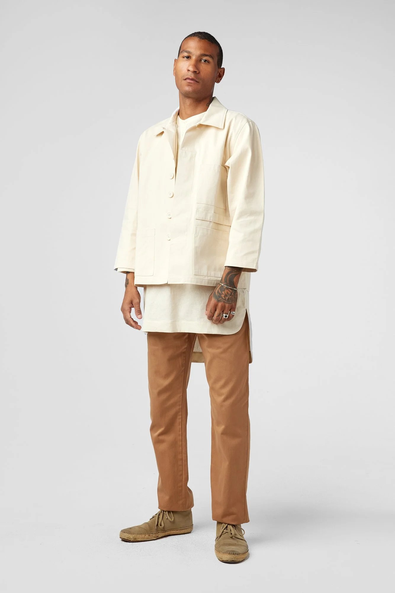 Man wearing bespoke sack coat uniform designed by Finery.