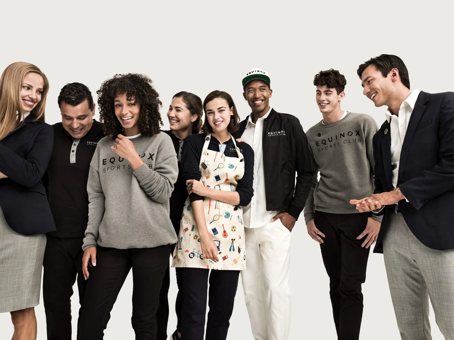 A group of Equinox employees wearing bespoke uniforms by Finery.