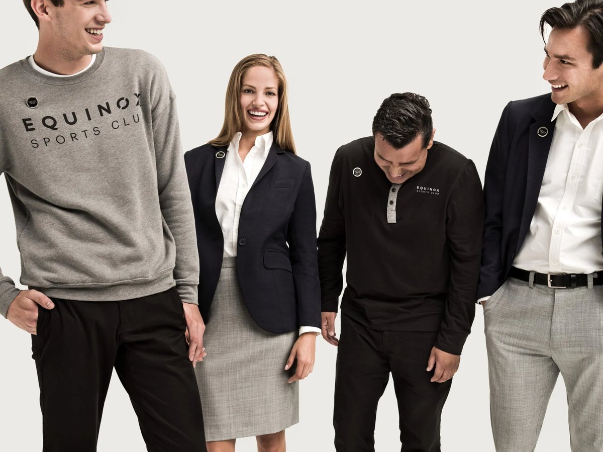 A group of Equinox employees wearing bespoke uniforms by Finery