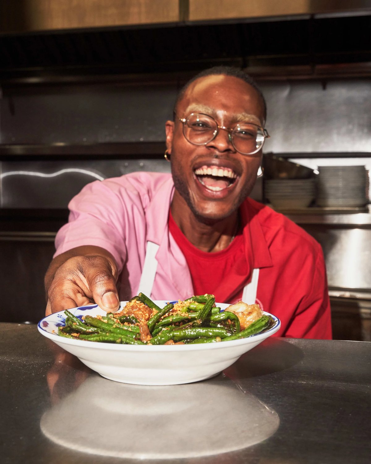 Man serving food while wearing Bonnie's custom two color shirt uniform by Finery.