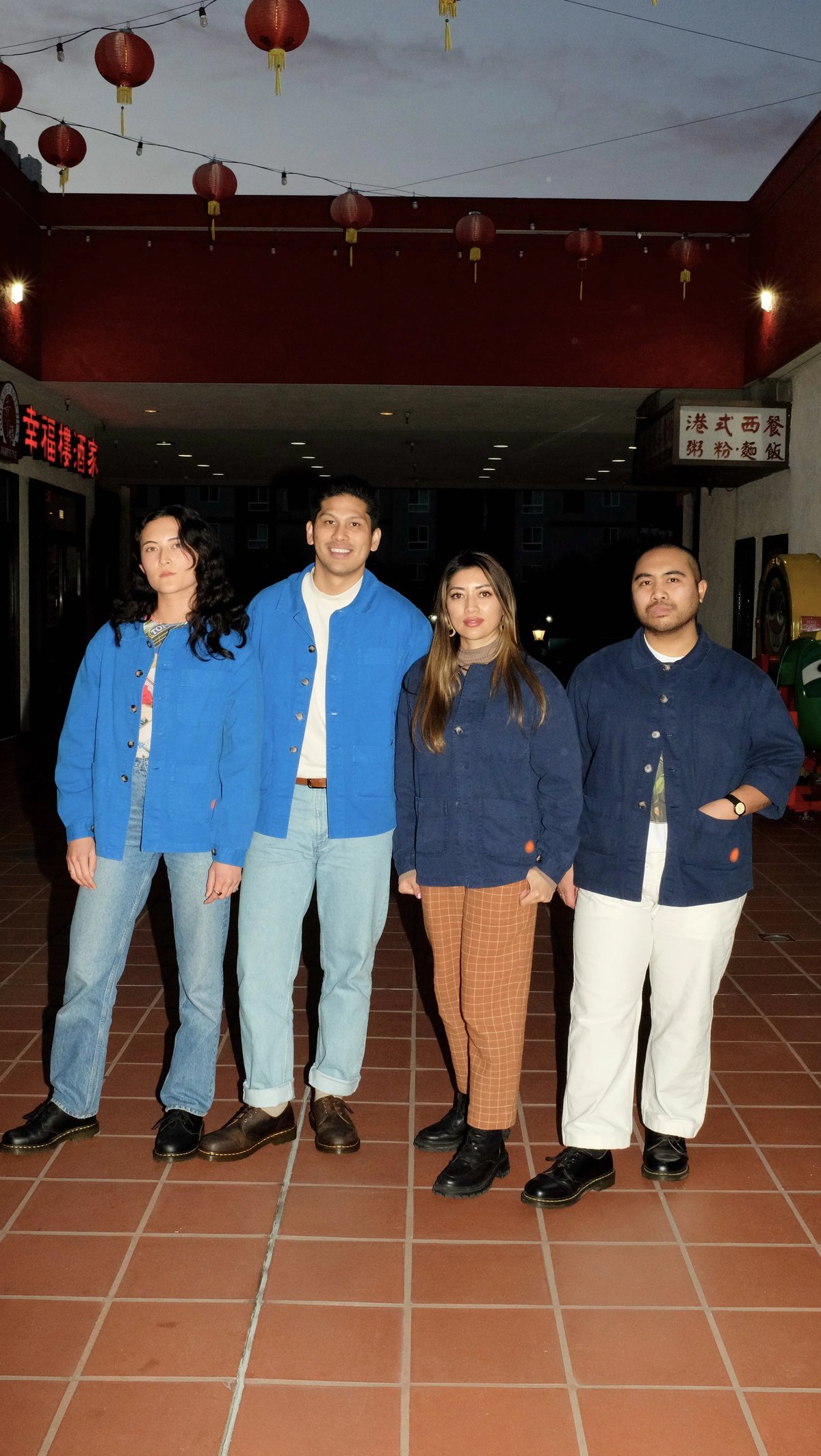 Group shot of Lasita workers wearing custom workwear jacket uniform designed by Finery.