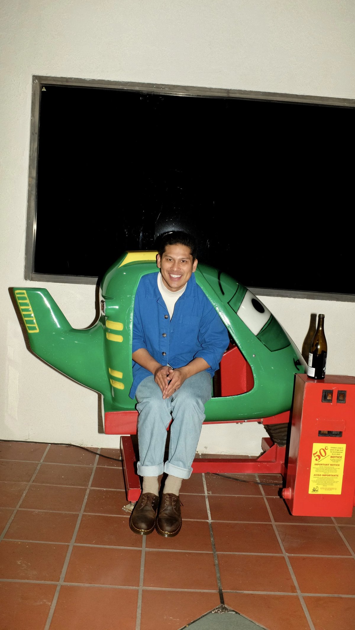 Person sitting wearing custom workwear Lasita jacket uniform designed by Finery.