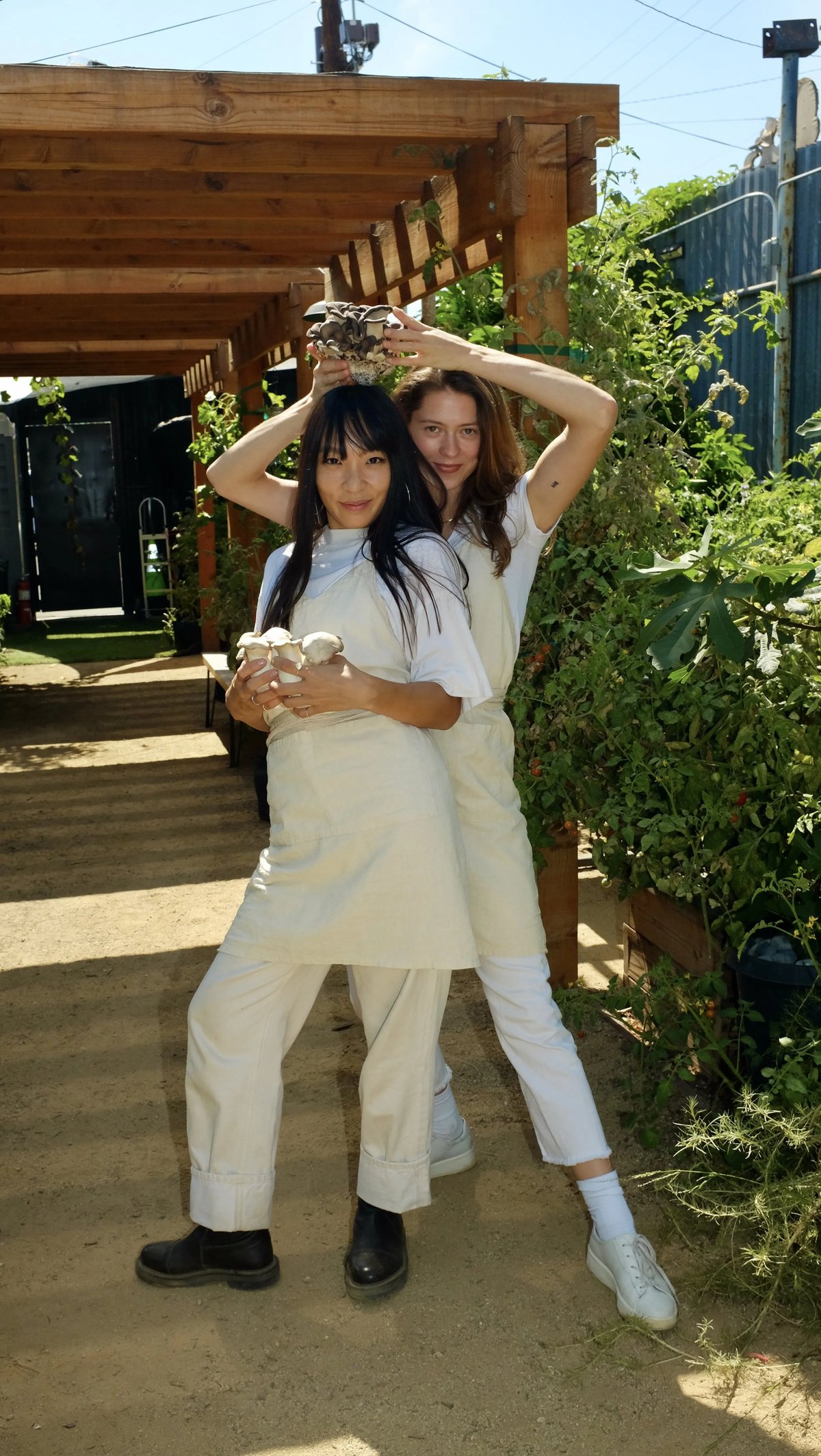 Sandy Ho wearing custom natural color linen apron designed by Finery.