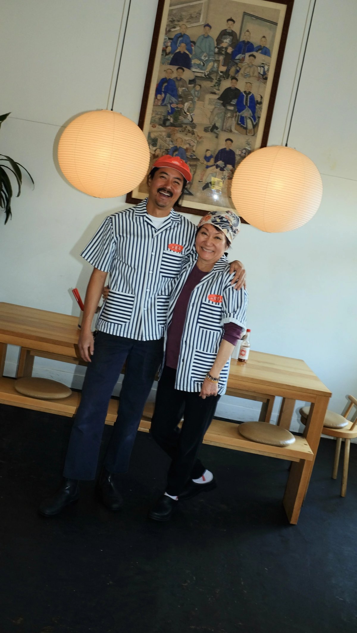 Keegan and Mama Fong wearing custom Woon work shirt uniform designed by Finery.