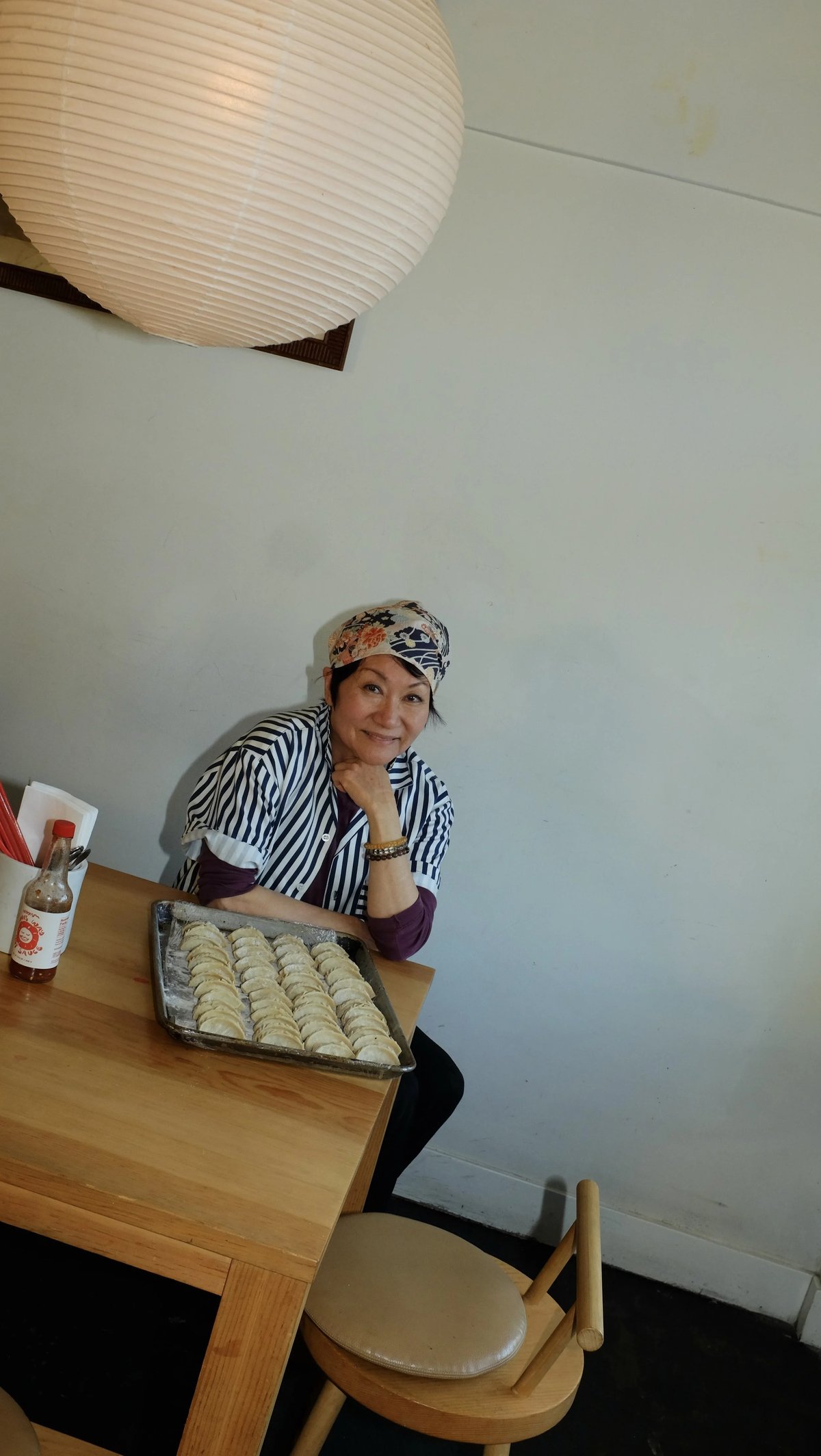 Mama Fong wearing custom Woon work shirt uniform designed by Finery.
