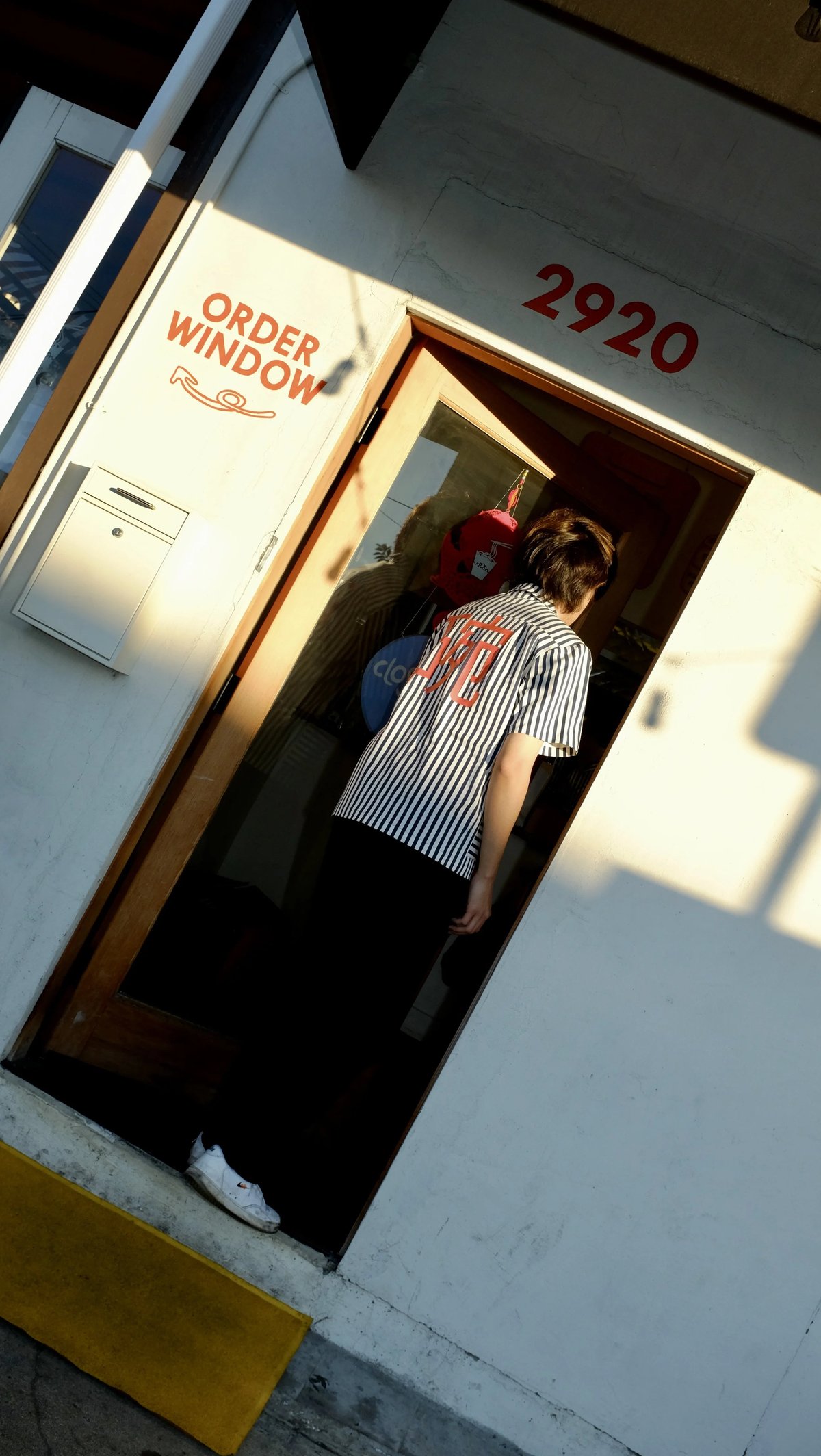 Walking into Woon wearing custom Woon work shirt uniform designed by Finery.