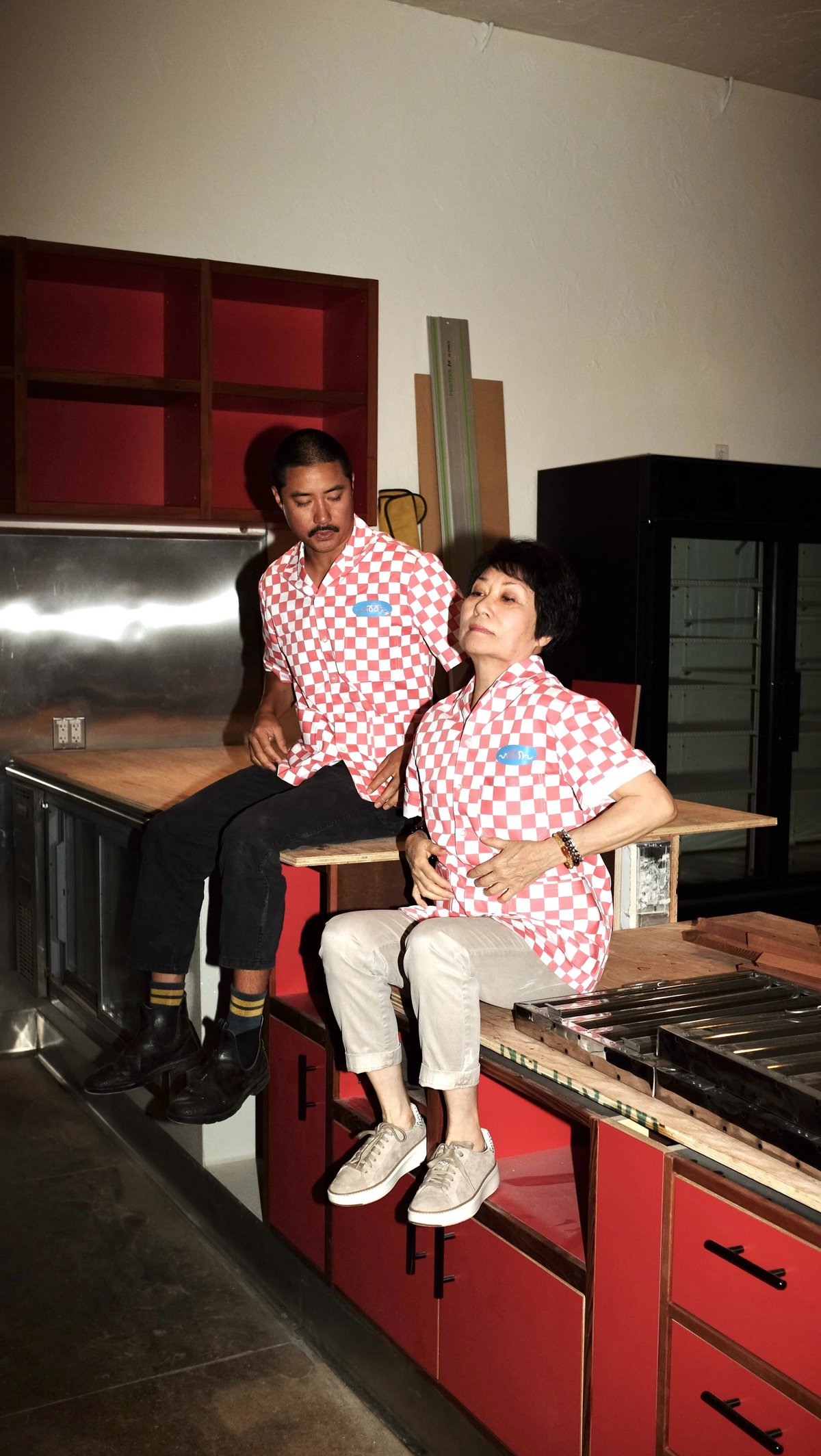 Two people wearing checkered Woon work shirt collaboration designed by Finery.
