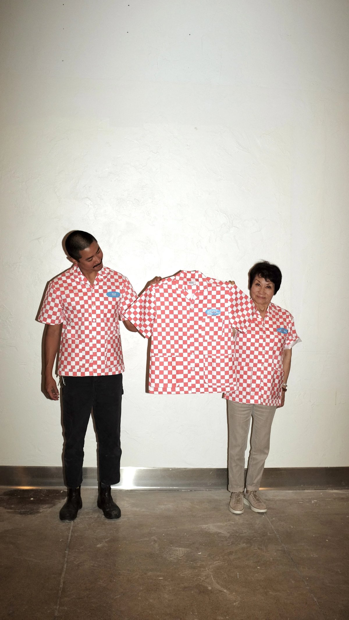 Holding up Woon work shirt collaboration designed by Finery.