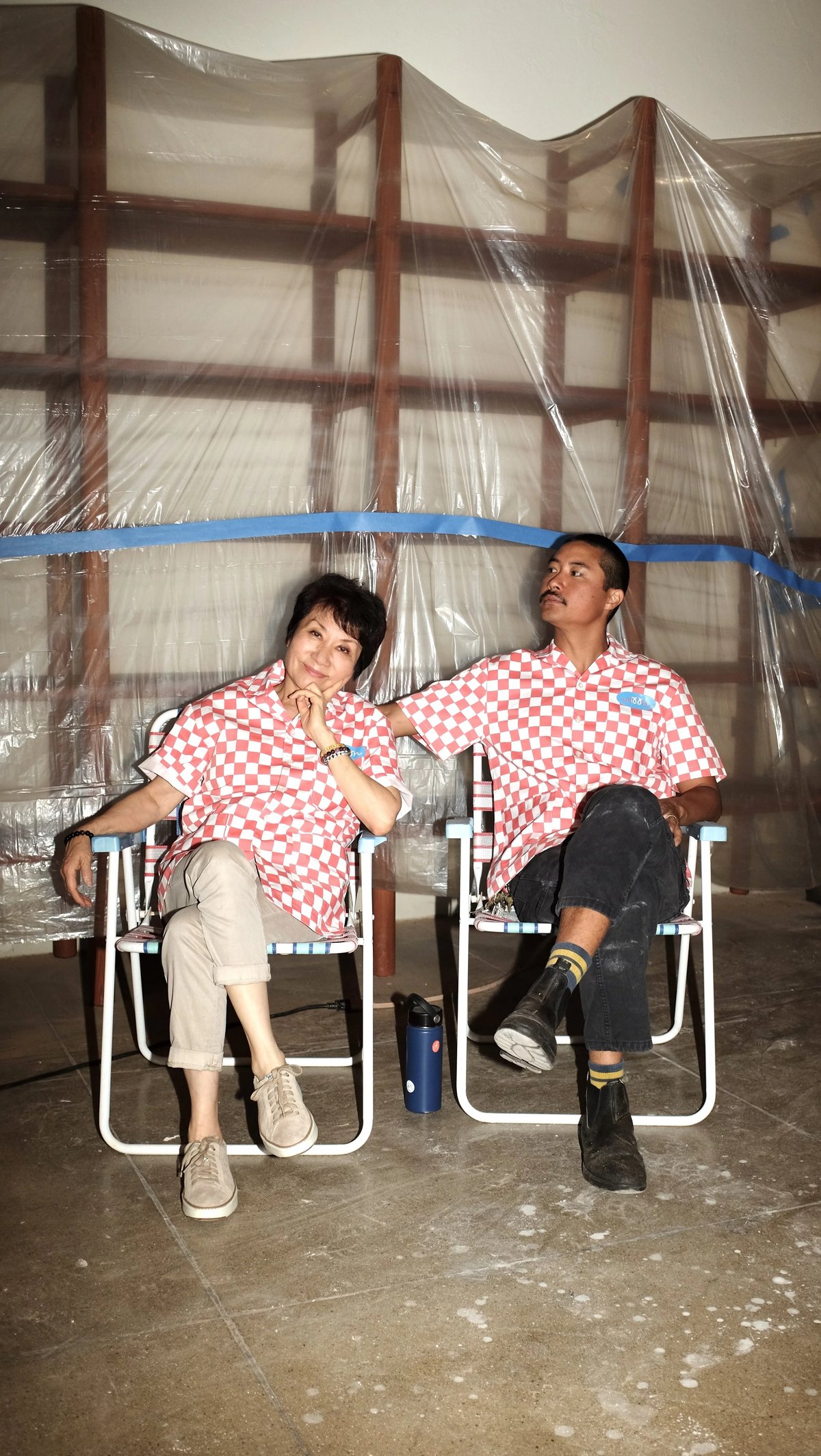 Two people sitting in lawn chairs wearing Woon work shirt collaboration designed by Finery.